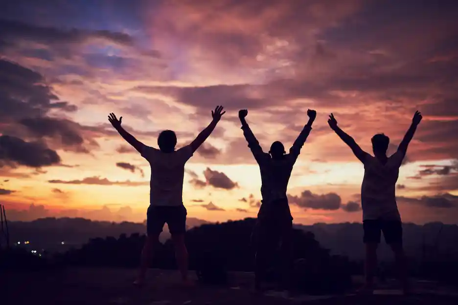 Three friends celebrating and enjoying their success together.