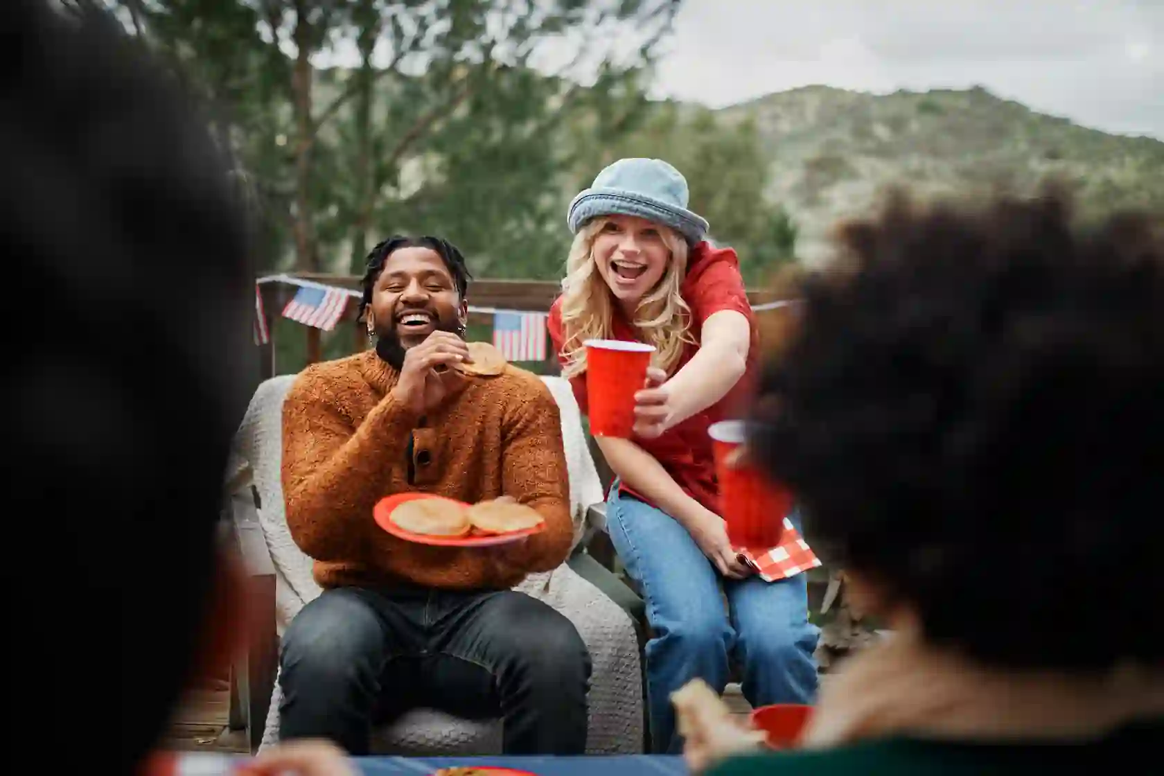 Friends enjoying outdoor meal together in natural setting